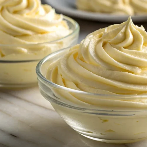 Silky French pastry cream in clear bowl, freshly whipped and creamy, vanilla flavor evident, professional culinary photograph